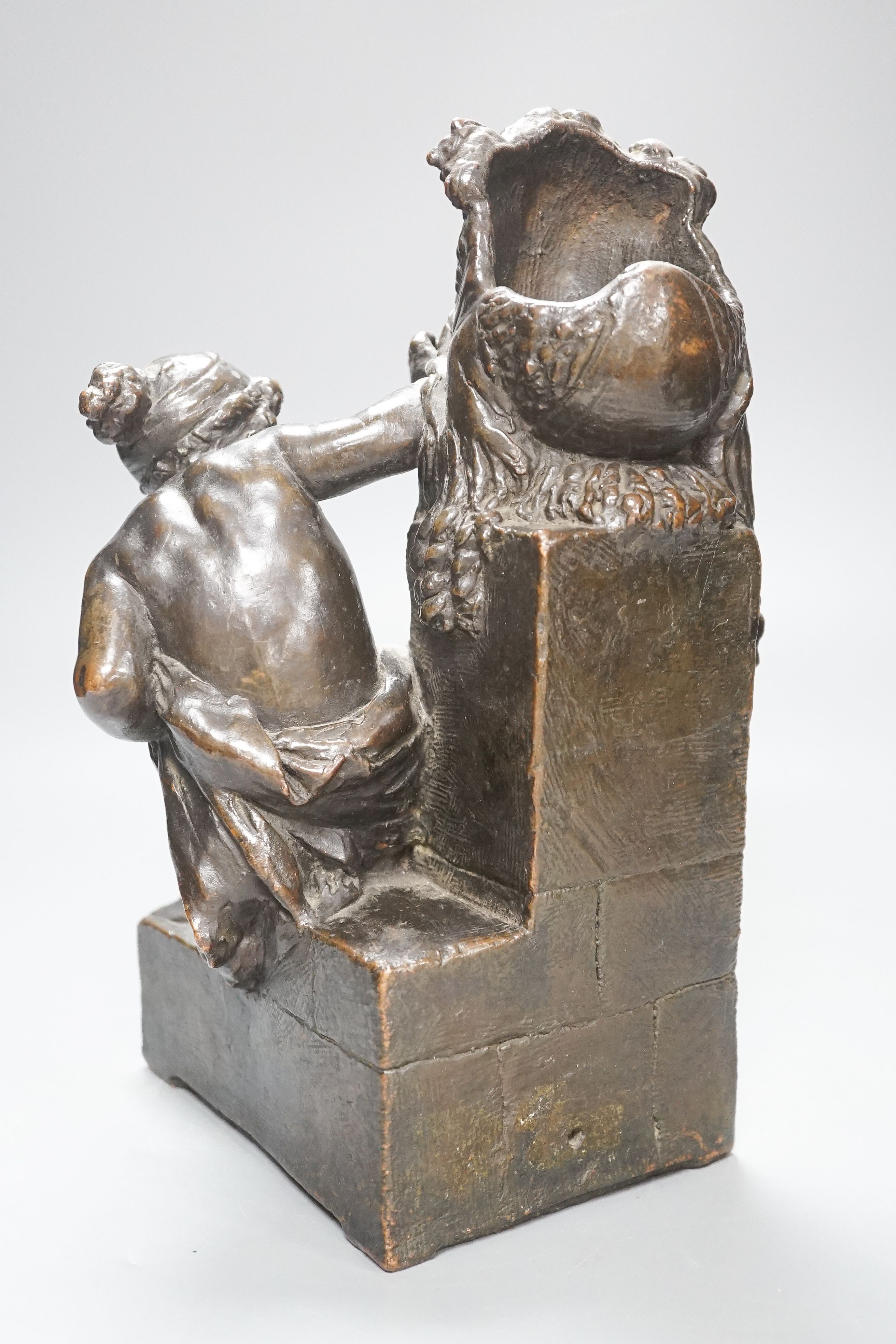 Gustave-Joseph Chéret (1838-1894). A bronzed terracotta group of putto beside a classical mask, signed, height 30cm